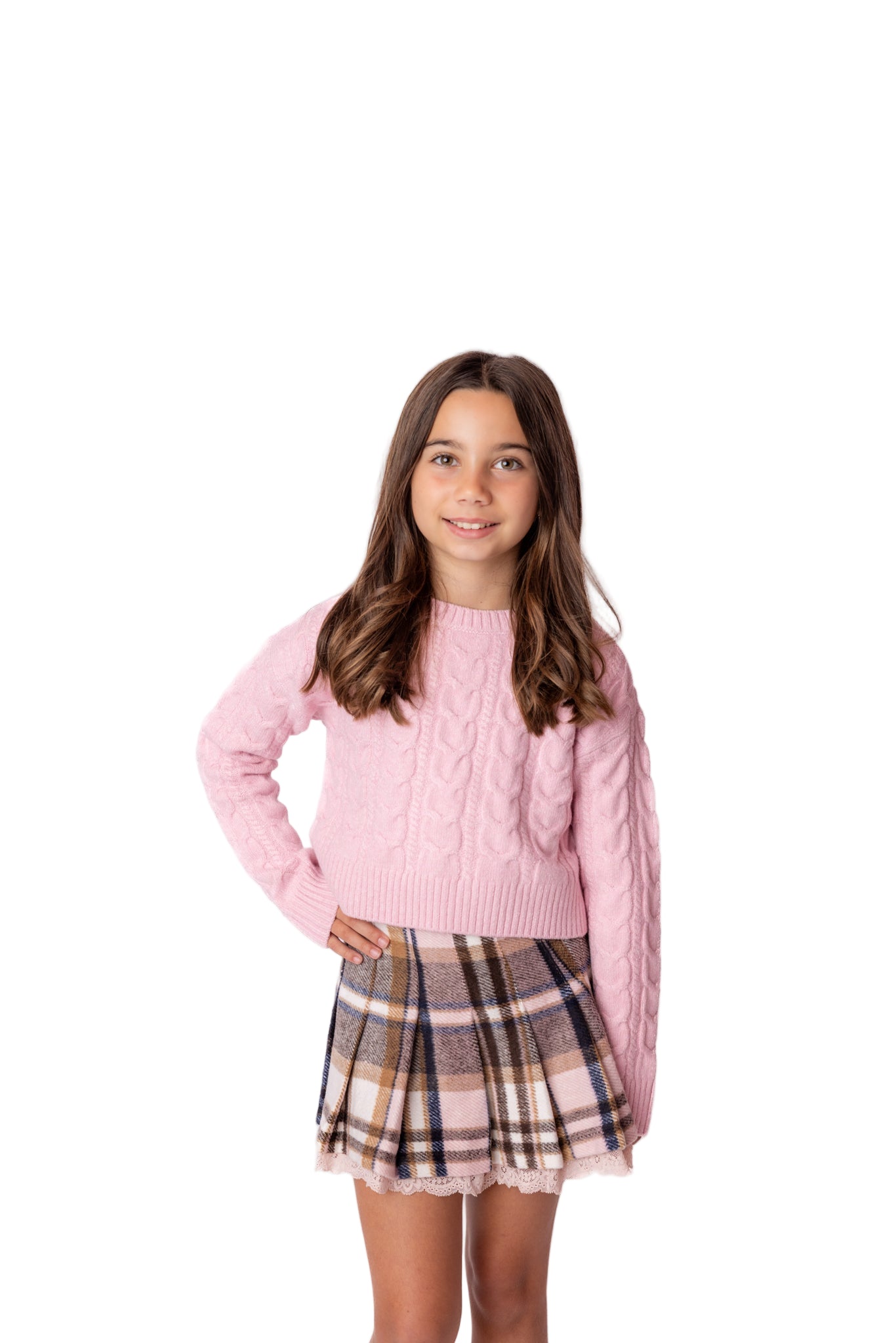 Young girl wearing a pink sweater and plaid skirt on a white background