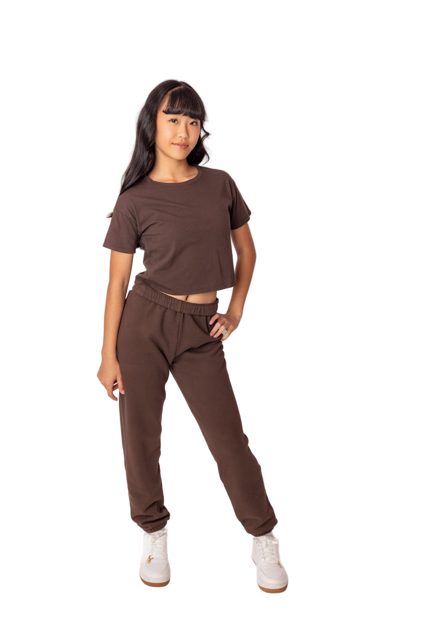 Woman wearing a brown outfit on a white background