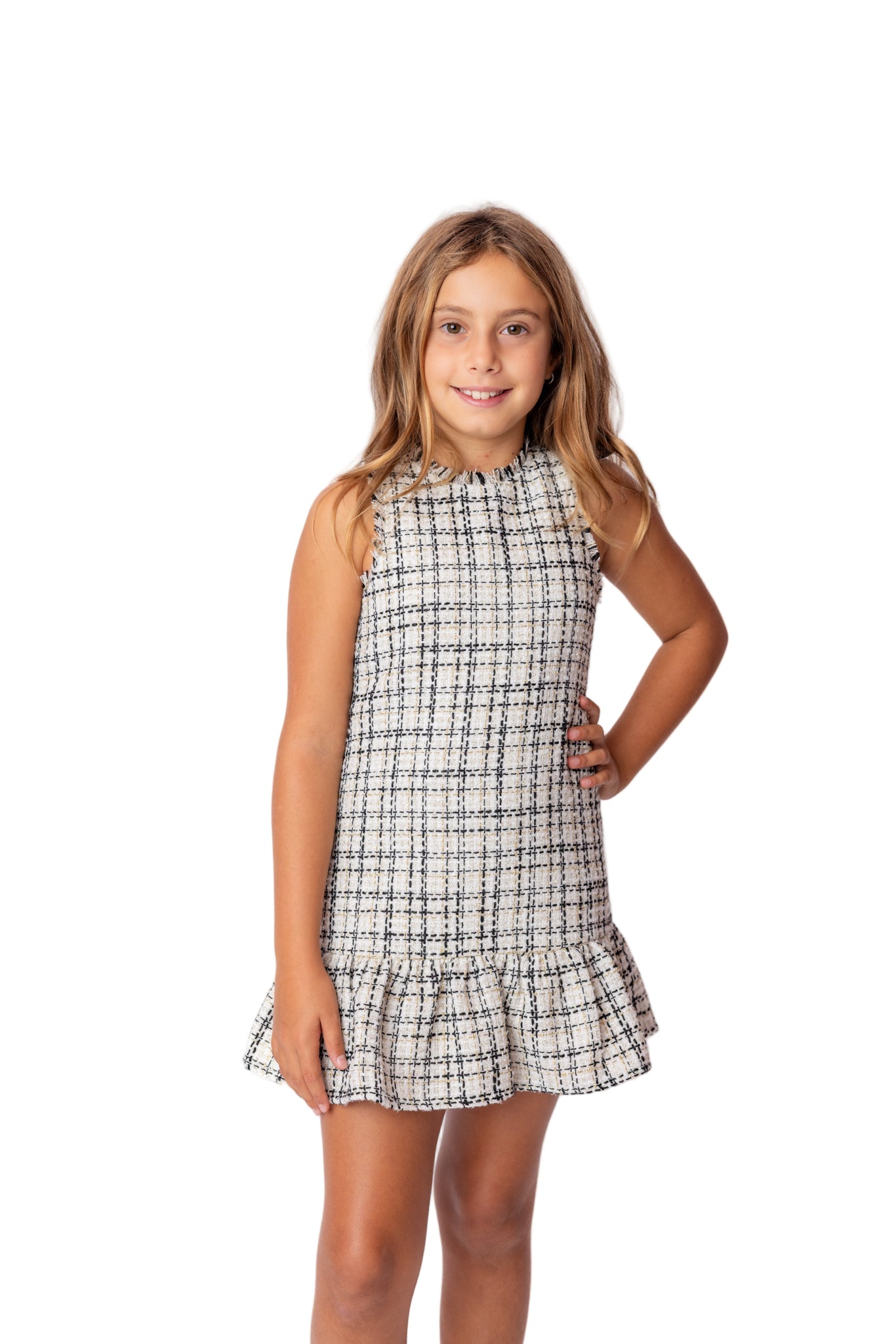 Young girl wearing a black and white tweed party dress for tweens and teens. Holiday shopping in newport beach