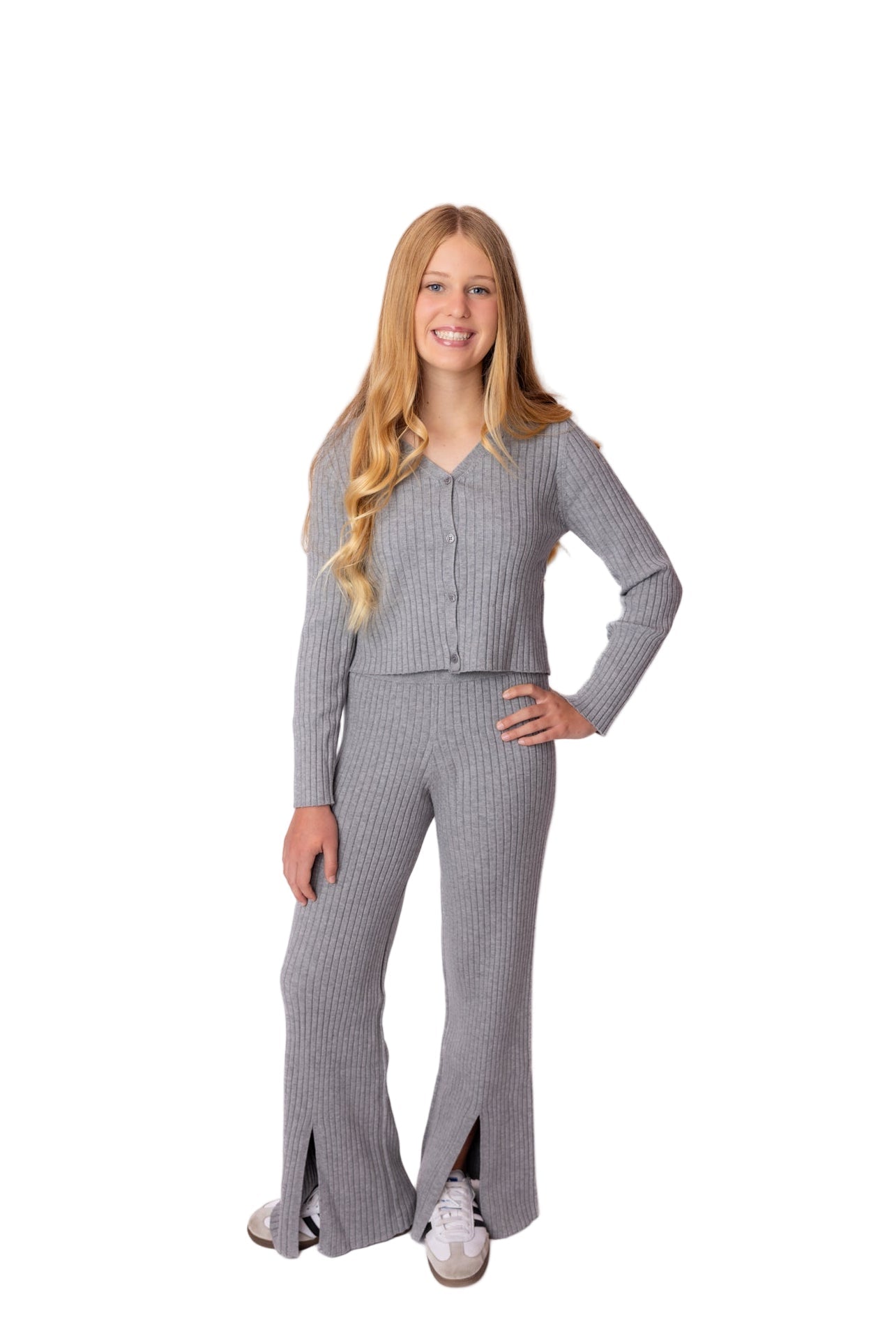 teen wearing a gray ribbed knit travel lounge outfit on a white background. Travel fits for teens and tweens. Lounge set from Riley + Cru new teen line