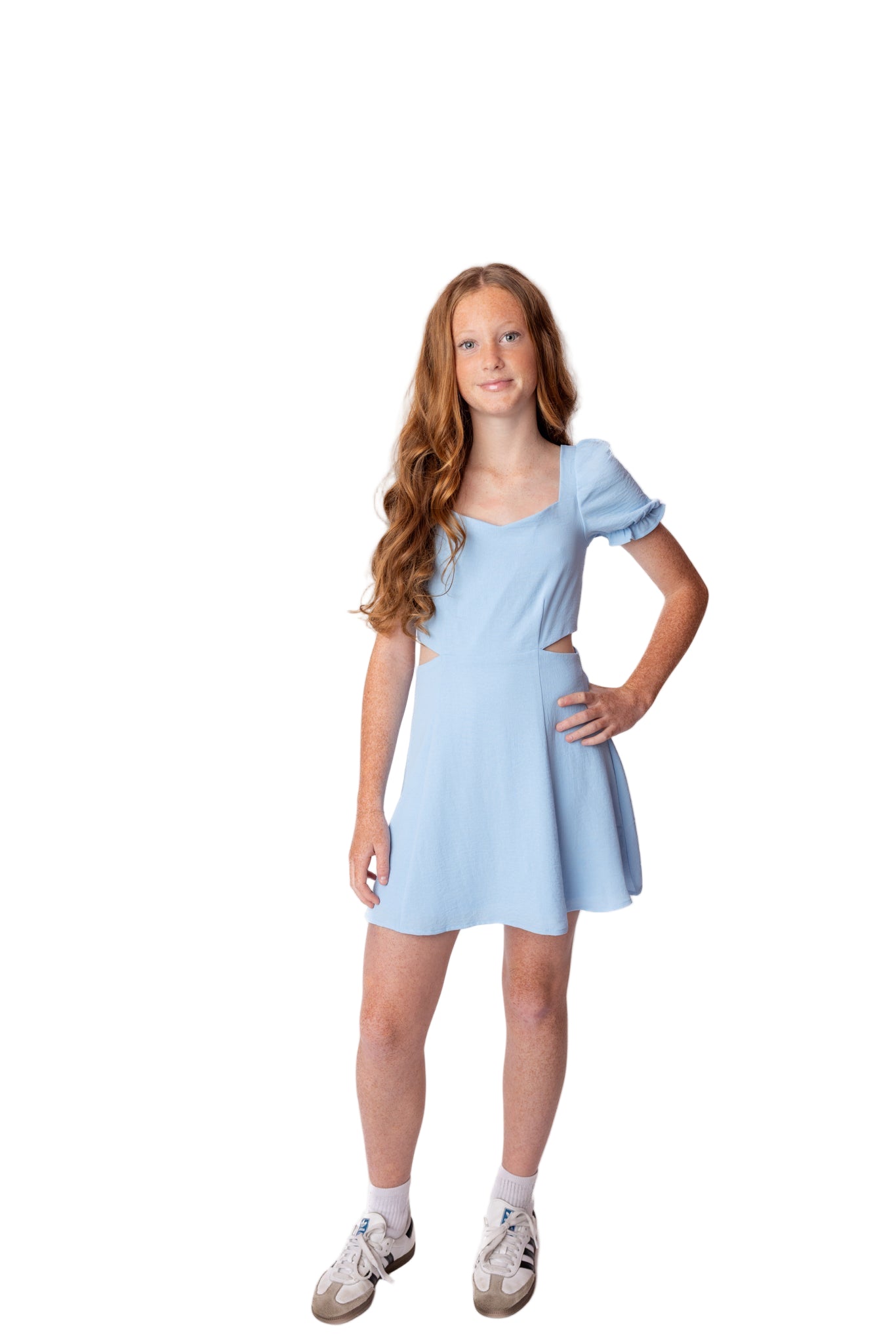 Young girl wearing a light blue dress on a white background